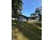 Charming single-story home with a well-maintained lawn and mature trees under a clear blue sky at 8855 N Waverly Park Rd, Martinsville, IN 46151