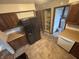 Cozy kitchen features wood cabinets, laminate countertops and view to laundry room with appliances at 8855 N Waverly Park Rd, Martinsville, IN 46151