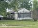 View of the home's backyard showing a trampoline, well kept lawn, and providing ample space for outdoor activities and relaxation at 1902 Edgemont Way, Anderson, IN 46011