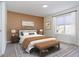 Warm bedroom with a large window, a bed with a brown accent wall and a decorative rug at 2068 S Avon Ave, Avon, IN 46123