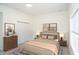 Bright bedroom with neutral tones, featuring a closet and a dresser at 2068 S Avon Ave, Avon, IN 46123