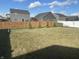 Spacious backyard with a well-maintained lawn and a privacy fence at 2018 Abbey Ln, Columbus, IN 47201