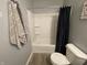 Clean bathroom featuring a shower-tub combo with modern fixtures and a gray-tone color scheme at 2018 Abbey Ln, Columbus, IN 47201