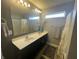 Modern bathroom featuring double sinks, neutral gray walls, and a shower at 2018 Abbey Ln, Columbus, IN 47201