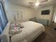 Bright bedroom with neutral carpet, ceiling fan, bed, and dressers at 2018 Abbey Ln, Columbus, IN 47201