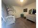 Charming Bedroom with a mural on the wall, crib, and neutral carpet at 2018 Abbey Ln, Columbus, IN 47201