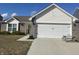 Charming single-Gathering home featuring a two-car garage and neatly landscaped front yard at 2018 Abbey Ln, Columbus, IN 47201