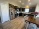 Modern kitchen featuring stainless steel appliances, dark cabinetry, and wood-look flooring at 2018 Abbey Ln, Columbus, IN 47201