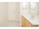 Bathroom featuring wooden vanity, white tile flooring, and entry door to the left at 4000 N Meridian St # 14A, Indianapolis, IN 46208