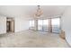 Spacious living room featuring large windows, chandelier, and neutral carpet at 4000 N Meridian St # 14A, Indianapolis, IN 46208