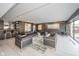 Modern condo lounge area with dark wood paneling, featuring sleek leather furniture and bar area at 4000 N Meridian St # 14A, Indianapolis, IN 46208