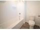 Bright bathroom with shower/tub combo and white vinyl flooring. Toilet and shower head also visible at 7888 Magnolia St, New Palestine, IN 46163