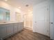 Bathroom featuring dual sink vanity, wood-look flooring and glass shower at 7888 Magnolia St, New Palestine, IN 46163