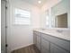 Bathroom with dual sink vanity, white countertops, gray cabinets, and wood look flooring at 7888 Magnolia St, New Palestine, IN 46163