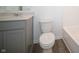 Modern bathroom featuring a toilet, gray vanity, and white countertop at 7888 Magnolia St, New Palestine, IN 46163