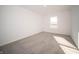 Sunlit bedroom features neutral walls and soft carpet, along with a large window at 7888 Magnolia St, New Palestine, IN 46163