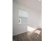 Bright bedroom featuring wood-look floors, crisp white walls, and a large window offering plenty of natural light at 7888 Magnolia St, New Palestine, IN 46163
