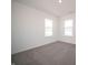 Bright bedroom featuring neutral carpet, white walls and trim and two large windows for natural light at 7888 Magnolia St, New Palestine, IN 46163