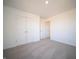 Well-lit bedroom featuring neutral carpet, white walls, and a double door closet for ample storage at 7888 Magnolia St, New Palestine, IN 46163