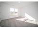 Bedroom features plush neutral carpet, natural light from large window, and light colored walls at 7888 Magnolia St, New Palestine, IN 46163