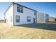 Rear exterior elevation of new construction home featuring a newly sodded yard and black trimmed windows at 7888 Magnolia St, New Palestine, IN 46163