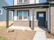 Charming front porch featuring brick accents, columns, and a stylish door, offering a welcoming entrance at 7888 Magnolia St, New Palestine, IN 46163