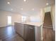 Modern kitchen with stainless steel dishwasher and sink situated in island, seamlessly integrating living and dining at 7888 Magnolia St, New Palestine, IN 46163