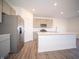 Bright kitchen featuring stainless steel appliances, gray cabinets, and an island with quartz countertop at 7888 Magnolia St, New Palestine, IN 46163