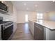 Contemporary kitchen boasts stainless steel appliances and a quartz countertop island at 7888 Magnolia St, New Palestine, IN 46163