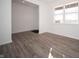Spacious living room featuring modern wood-look flooring, crisp white walls, and abundant natural light at 7888 Magnolia St, New Palestine, IN 46163