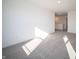 Spacious living room features neutral walls and carpet, leading to other areas at 7888 Magnolia St, New Palestine, IN 46163