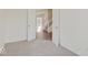 Neutral carpeted bedroom with adjoining room providing options for use as ensuite or flex space at 3567 Windstar Ct, Columbus, IN 47203