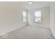 Bright, carpeted bedroom featuring two windows allowing natural light at 3567 Windstar Ct, Columbus, IN 47203