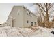 Rear exterior of home with gray siding, white trim, and a snowy yard at 3567 Windstar Ct, Columbus, IN 47203