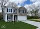 Two-story home with brick and siding, black shutters, and a well-manicured lawn at 3567 Windstar Ct, Columbus, IN 47203