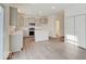 A bright kitchen features gray cabinets, an island, stainless steel appliances, and wood-look flooring at 3567 Windstar Ct, Columbus, IN 47203
