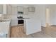 A bright kitchen features gray cabinets, an island, stainless steel appliances, and quartz countertops at 3567 Windstar Ct, Columbus, IN 47203