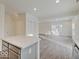 An open kitchen features gray cabinets, an island, stainless steel appliances, and quartz countertops at 3567 Windstar Ct, Columbus, IN 47203