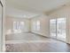 A bright living room is well-lit and features wood-look flooring and a glass patio door at 3567 Windstar Ct, Columbus, IN 47203