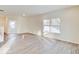 Light-filled living room featuring modern wood flooring and large windows offering scenic views at 3567 Windstar Ct, Columbus, IN 47203