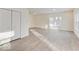 A bright living room is well-lit and features wood-look flooring and double-door closets at 3567 Windstar Ct, Columbus, IN 47203