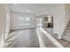 Spacious living room with wood floors, large windows, and an open layout to the kitchen and staircase at 3567 Windstar Ct, Columbus, IN 47203