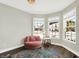 Bright sitting area featuring a round plush chair, elegant rug, and sun-filled bay windows at 5424 Pembridge Ln, Zionsville, IN 46077