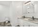 Bright bathroom featuring a double sink vanity with gray countertop and modern fixtures at 1127 S Pershing Ave, Indianapolis, IN 46221