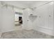 Bright bedroom featuring carpet, a closet, and doorway view of a kitchen at 1127 S Pershing Ave, Indianapolis, IN 46221