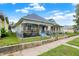 Exterior view of a quaint home featuring blue siding, brick accents, and a tidy lawn, showcasing a classic suburban charm at 1127 S Pershing Ave, Indianapolis, IN 46221