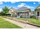 View of home with blue siding, brick details, and a chain-link fence, displaying its curb appeal on a sunny day at 1127 S Pershing Ave, Indianapolis, IN 46221