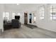 Bright living room with hardwood floors, neutral tones, and ample natural light, creating a welcoming and comfortable ambiance at 1127 S Pershing Ave, Indianapolis, IN 46221