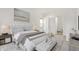 Serene main bedroom with neutral color palette, tufted headboard, and a stylish ottoman, creating a relaxing retreat at 1127 S Pershing Ave, Indianapolis, IN 46221