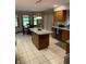 Bright kitchen features an island, hardwood cabinets and tile floors at 466 Sycamore Ridge Ct, Avon, IN 46123